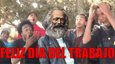 a group of people are standing around a man with a beard and the words feliz dia del trabajo in red