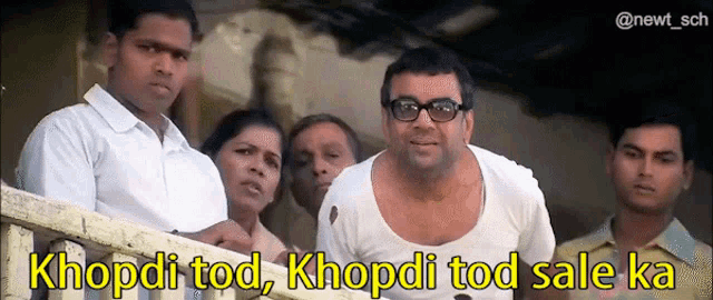 a group of people are standing around a man with the words khopdi tod khopdi tod sale ka written above him