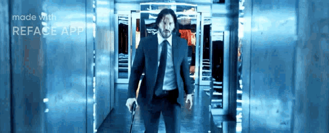 a man in a suit and tie is walking down a hallway holding a cane ..
