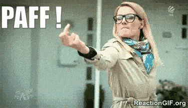 a woman wearing glasses and a trench coat is giving the middle finger