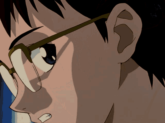 a close up of a man 's face with glasses