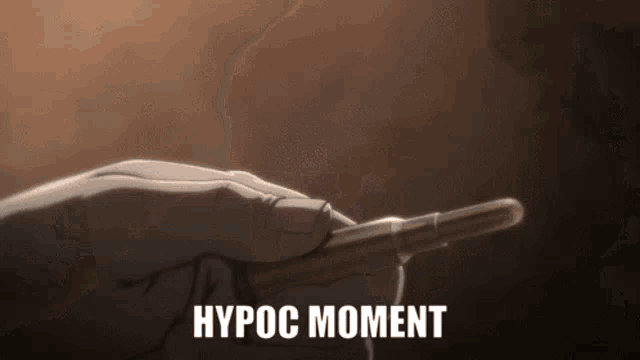 a hand is holding a bullet with hypoc moment written on it .
