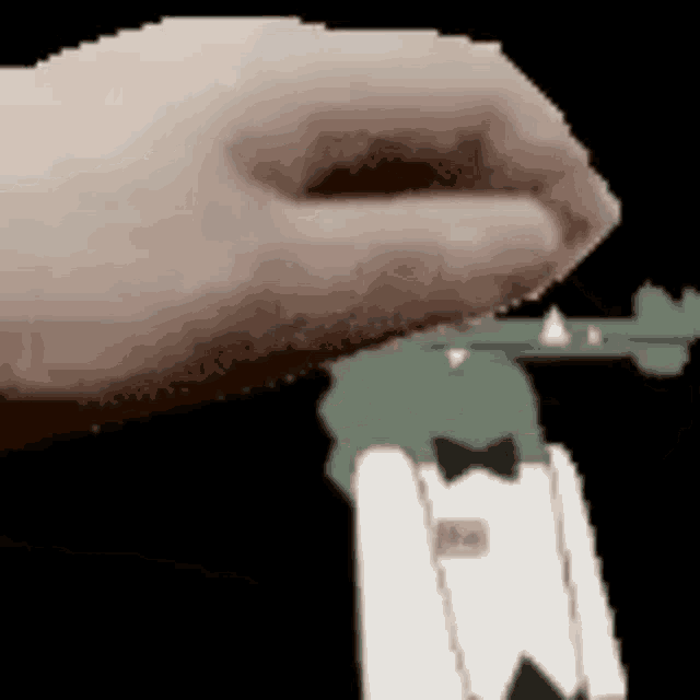 a close up of a person 's hand holding a gun with a cartoon character in the background .