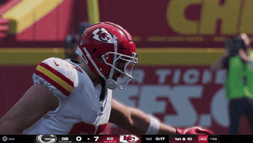 a football player wearing a helmet with the kc logo