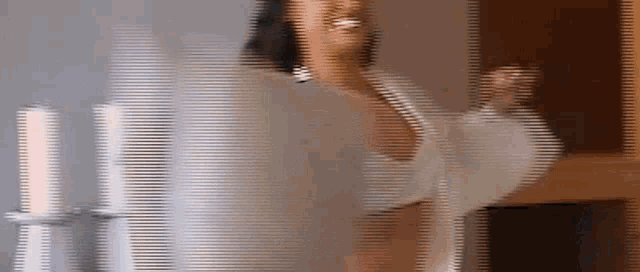 a blurred image of a woman in a white dress