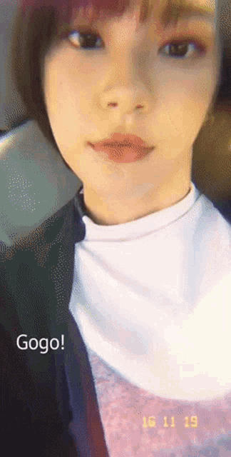 a close up of a woman 's face with the words gogo written below her