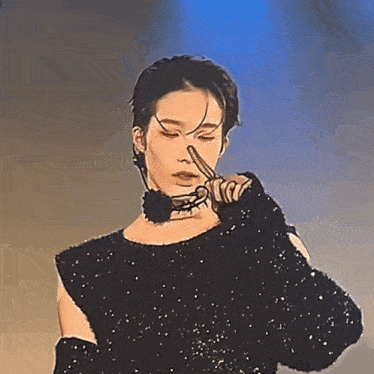 a man wearing a black sweater and black gloves is holding his nose