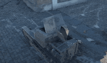 a gray vehicle is parked on a brick pavement