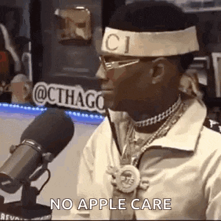a man wearing a headband that says gucci is talking into a microphone .