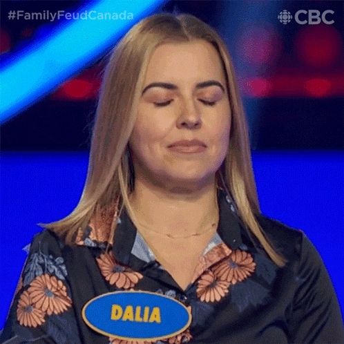 a woman is wearing a name tag that says dalia on it
