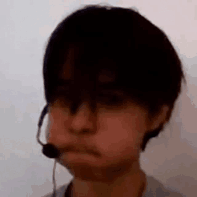 a close up of a person wearing a headset and making a face .