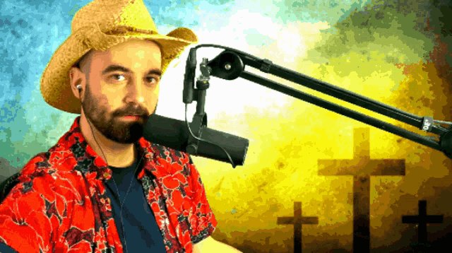 a man wearing a cowboy hat and ear buds stands in front of a microphone with crosses in the background