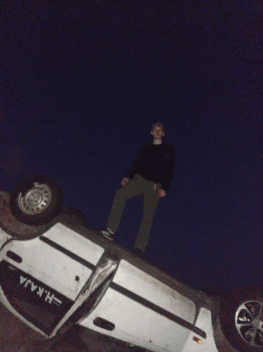 a man is standing on top of a car that has the letters h.k.raja written on it
