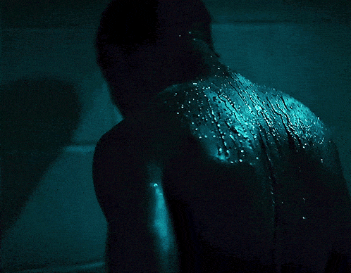 a man 's back is covered in blue sparkles