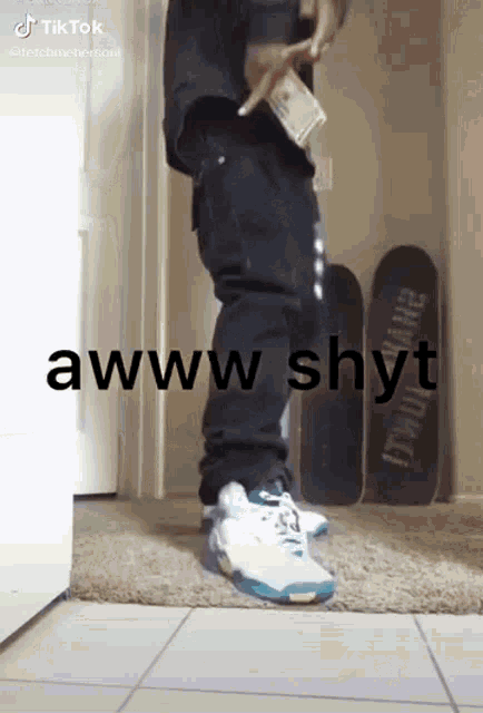 a man is standing in a hallway holding a bag of money and a skateboard .