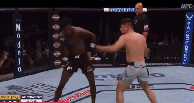 two men are fighting in a boxing ring with a banner that says autozone on it