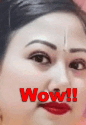 a close up of a woman 's face with the word wow written in red