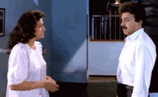 a man and woman are standing next to each other in a room .