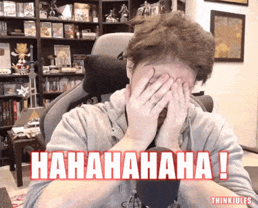 a man covering his face with his hands and the words ' hahahaha ! ' written in red