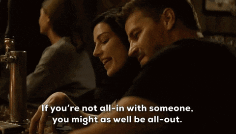 a man and a woman are sitting at a table and the man says if you 're not all-in with someone