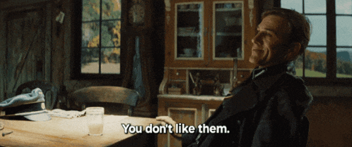a man sits at a table with the words " you don 't like them " on the bottom