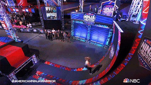 a group of people are standing in front of a sign that says ninja warrior