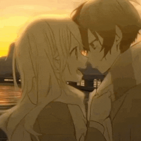 a boy and a girl are kissing each other in front of a sunset .