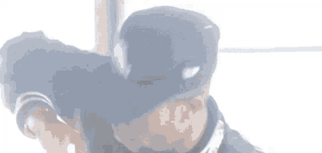 a person is laying on the floor with their arms outstretched and their face obscured .