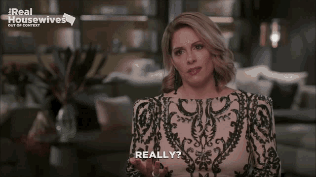 a woman says really in front of a real housewives logo