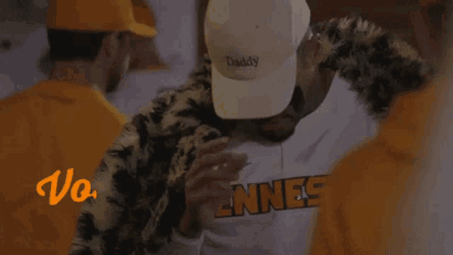 a man wearing a white hat that says " daddy "