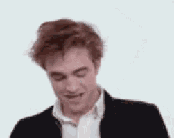 a close up of a man laughing with his eyes closed