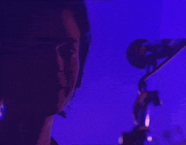 a close up of a person 's face with a purple background