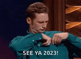 a man in a blue shirt is looking at his watch and says `` see ya 2023 '' .