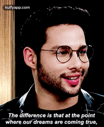 a man wearing glasses is smiling and says the difference is that at the point where our dreams are coming true .