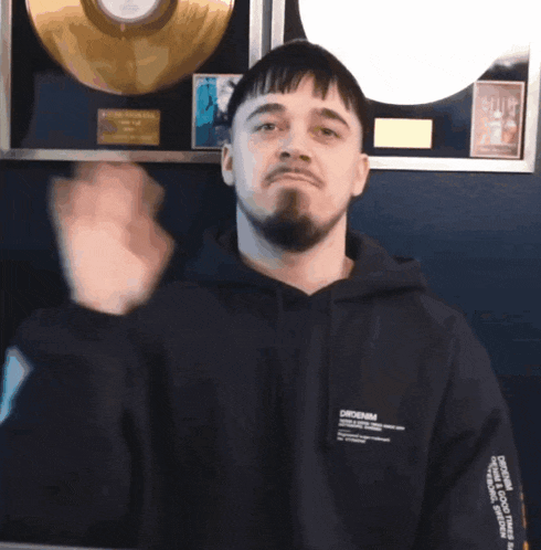 a man wearing a black hoodie that says orddenim
