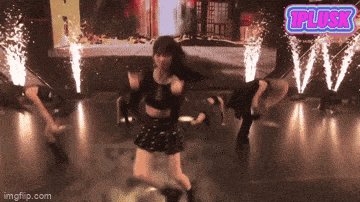 a group of people are dancing on a stage with a sign that says tplusk