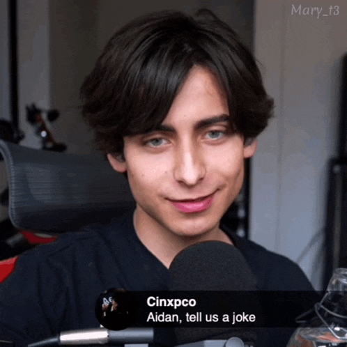 a young man talking into a microphone with the caption cinxpco