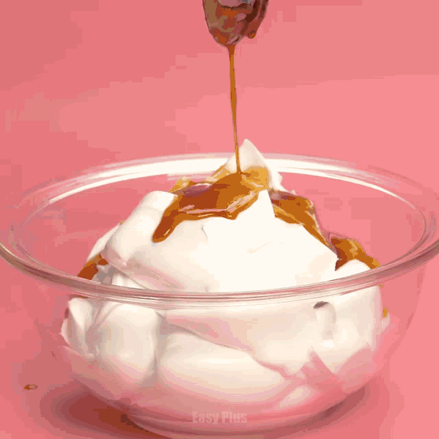 a bowl of whipped cream with caramel being poured over it and easy plus written on the bottom