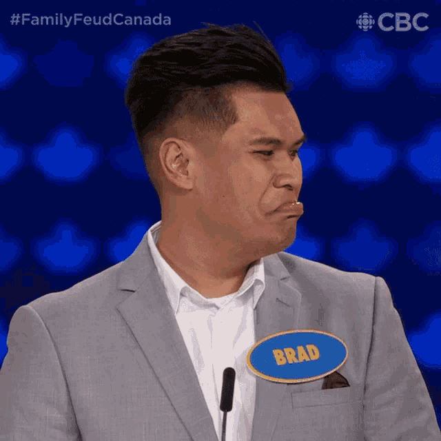 a man in a suit has a name tag that says brad on it