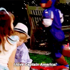 a little boy in a captain america costume is talking to a little girl