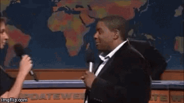 a woman is touching a man 's face while talking into a microphone and says you 're just to good