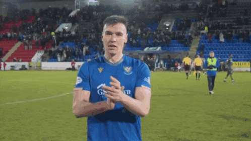 a soccer player wearing a blue shirt that says gazprom on it