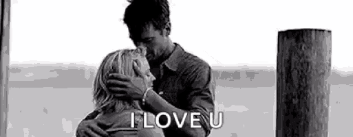 a man is hugging a woman in a black and white photo and says `` i love u '' .