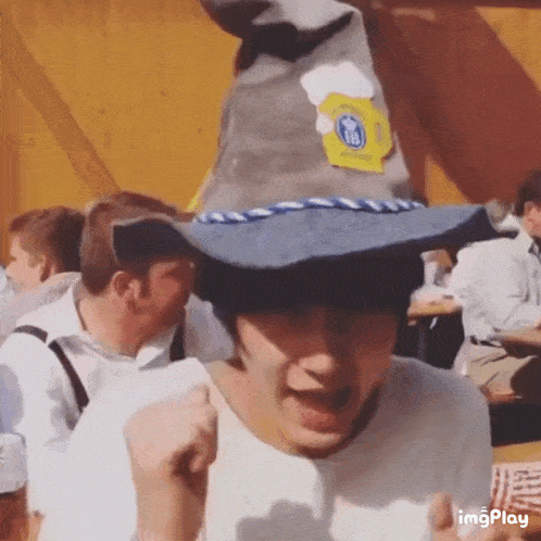 a man wearing a wizard hat with a beer on it