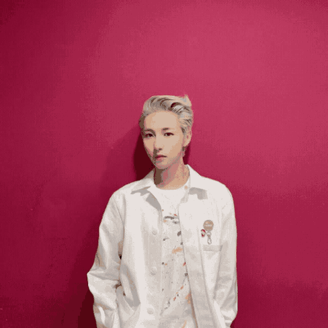 a person wearing a white coat with a key pin on it