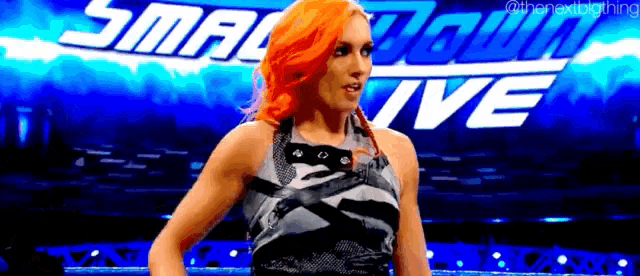 a woman is standing in front of a sign that says smackdown live