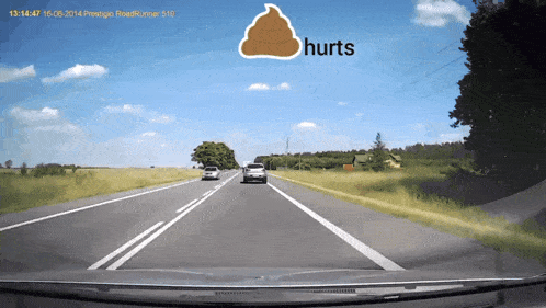a car is driving down a highway with a sign that says " hurts "