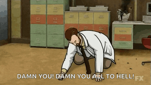 a man in a lab coat and tie is kneeling down on the floor in a room .