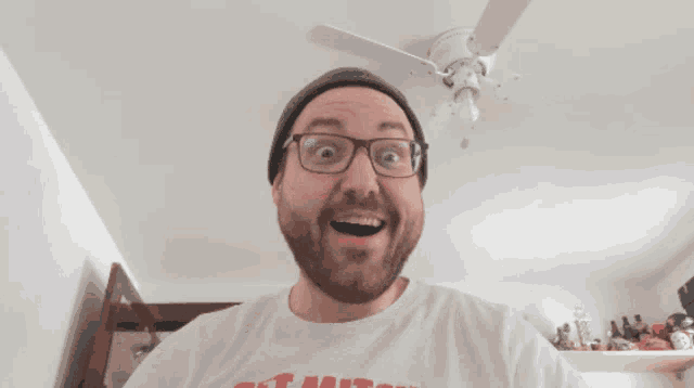 a man wearing glasses and a t-shirt that says ' ch '