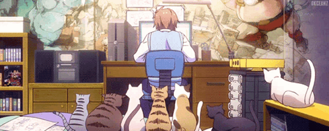 a man is sitting at a desk with a bunch of cats sitting around him